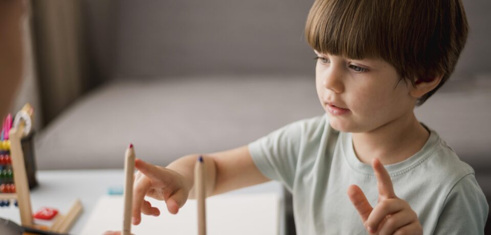 side-view-child-learning-how-count-home-using-pencils side-view-child-learning-how-count-home-using-pencils