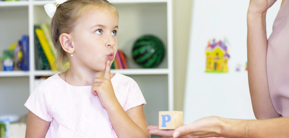 Speech therapist teaches the girl to say the letter Speech therapist teaches the girl to say the letter